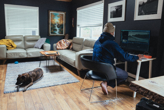 nate laverty cinematographer wearing tofino surfing association quiver hoody at home with dog editing